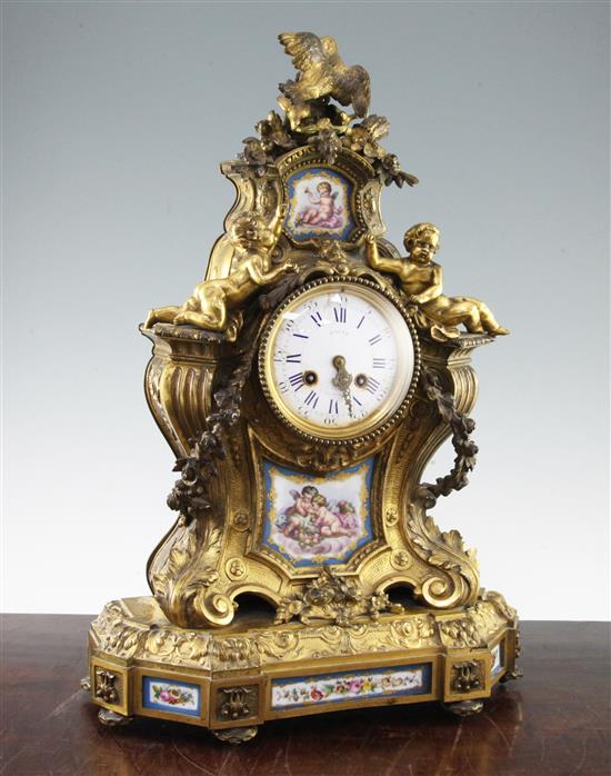 A 19th century French ormolu and Sevres style porcelain mantel clock, 21in.